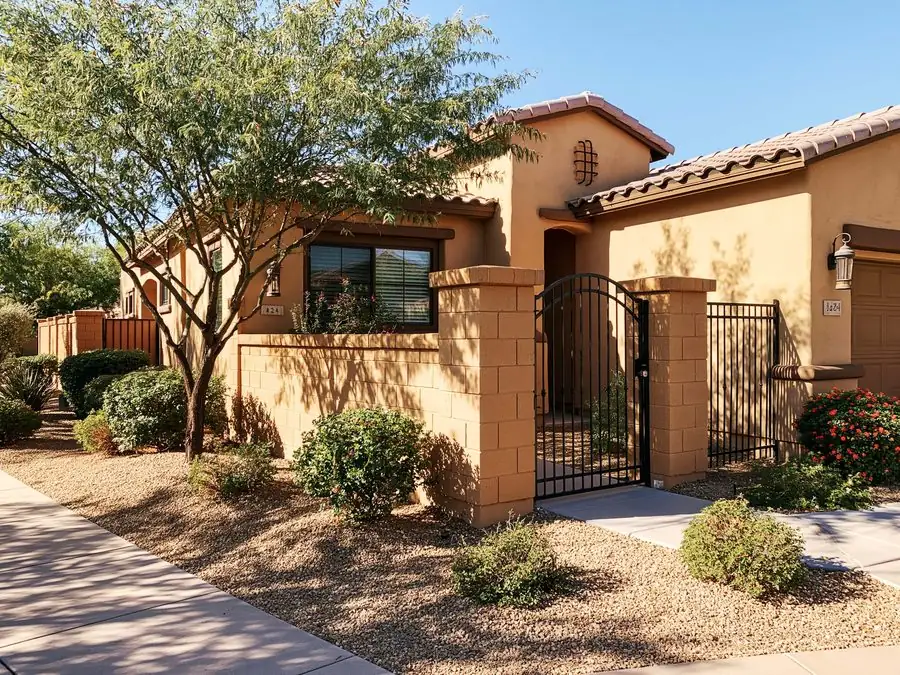 Finished block wall, iron gate and tidy desert front yard at a Tempe, AZ home